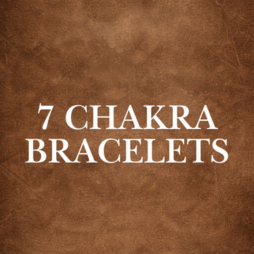 Crystal Chakra Bracelets Collection featuring authentic chakra stones for balance and harmony, displayed on amethyst crystals.