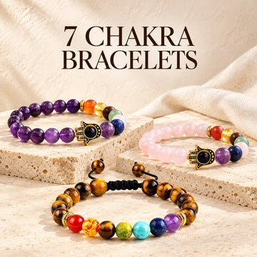 7 Chakra Bracelets displayed on ivory stone at Ancient Infusions.