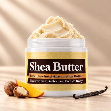 Ancient Infusions African shea body butter in an open white jar with shea nuts, mango and vanilla on a soft ivory background