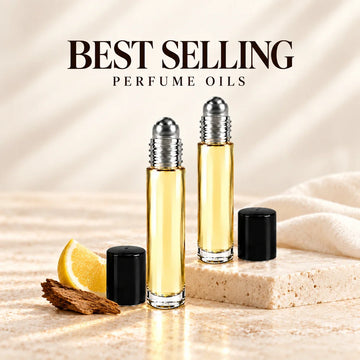 Best selling perfume oil roller bottles with citrus and wood accents on ivory stone