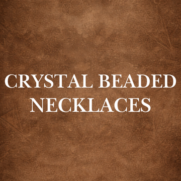 Hand holding multiple Crystal Beaded Necklaces outdoors, showcasing colorful handcrafted healing beads.