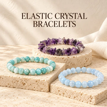 Amazonite, amethyst chip and aquamarine elastic crystal bracelets on ivory stone.