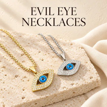 Evil Eye Necklaces collection jewelry arranged on warm ivory stone at Ancient Infusions.