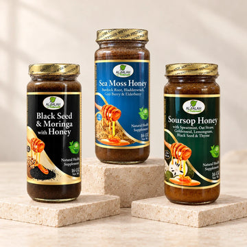 Black Seed and Moringa, Sea Moss, and Soursop herbal honey jars on ivory stone