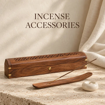 Wooden incense box and wooden and ceramic incense holders on ivory stone.