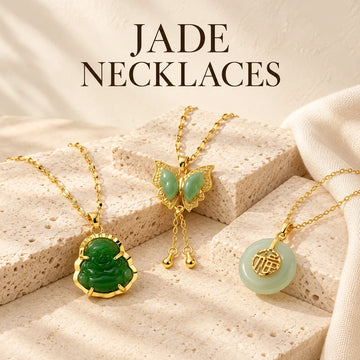 Jade Necklaces collection jewelry arranged on warm ivory stone at Ancient Infusions.