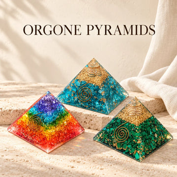 Rainbow chakra, aquamarine and malachite orgone pyramids on ivory stone.
