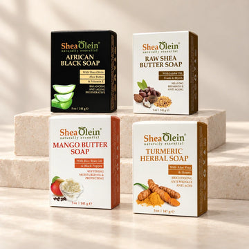 Shea Olein African Black, Raw Shea Butter, Mango Butter, and Turmeric soap boxes on ivory stone