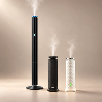 ASCENT floor-standing, black HAVEN Air Pro, and white HAVEN Air waterless aroma diffusers on a soft neutral background.