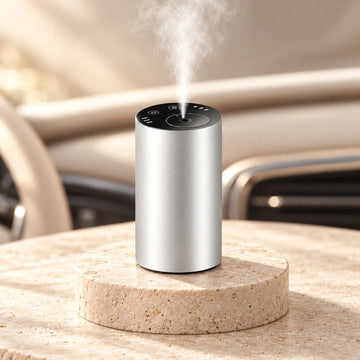 Silver waterless car diffuser on an ivory pedestal