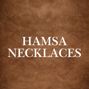 Intricately designed Hamsa Necklaces Collection piece in stainless steel on rustic wood background, symbolizing protection and elegance.