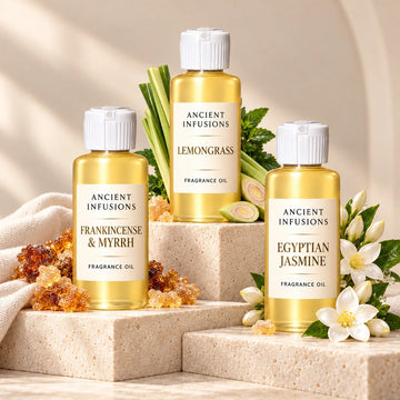 Frankincense, lemongrass, and jasmine ritual oils on ivory stone