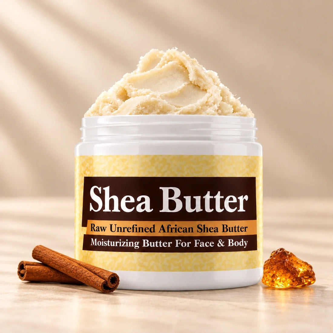 Amber Gold Shea Butter in an open white jar with textured ivory shea butter and subtle scent accents on a soft cream background.
