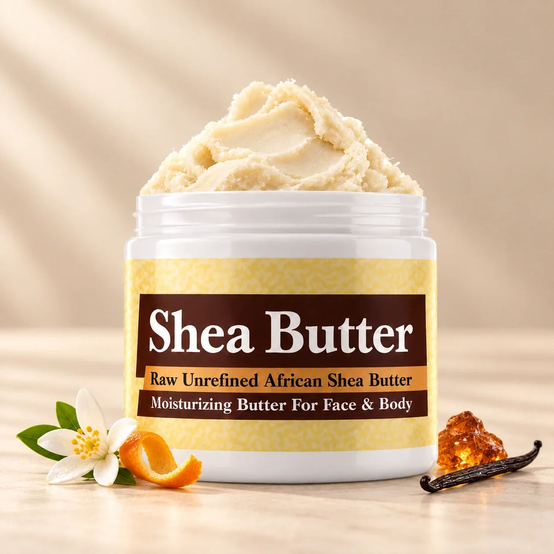 Amber White Shea Butter in an open white jar with textured ivory shea butter and simple citrus, white blossom, amber and vanilla scent accents on a soft cream background.