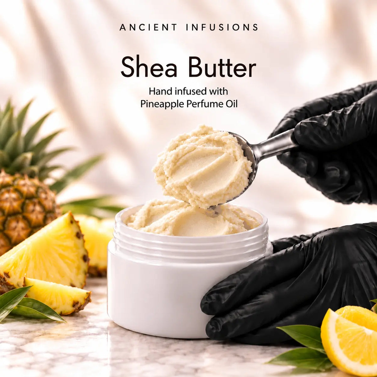 Black vinyl-gloved hands scoop raw shea butter hand infused with Pineapple perfume oil.