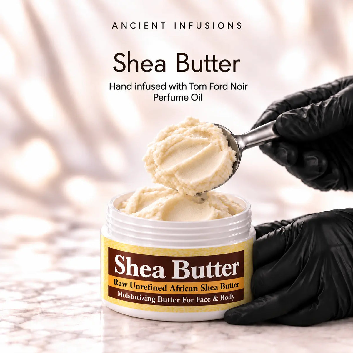 Black vinyl-gloved hands scoop raw shea butter hand infused with Tom Ford Noir perfume oil.