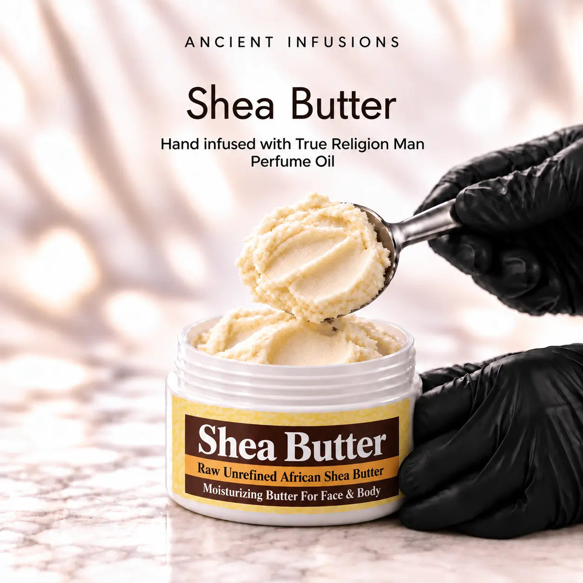 Black vinyl-gloved hands scoop raw shea butter hand infused with True Religion Man perfume oil.