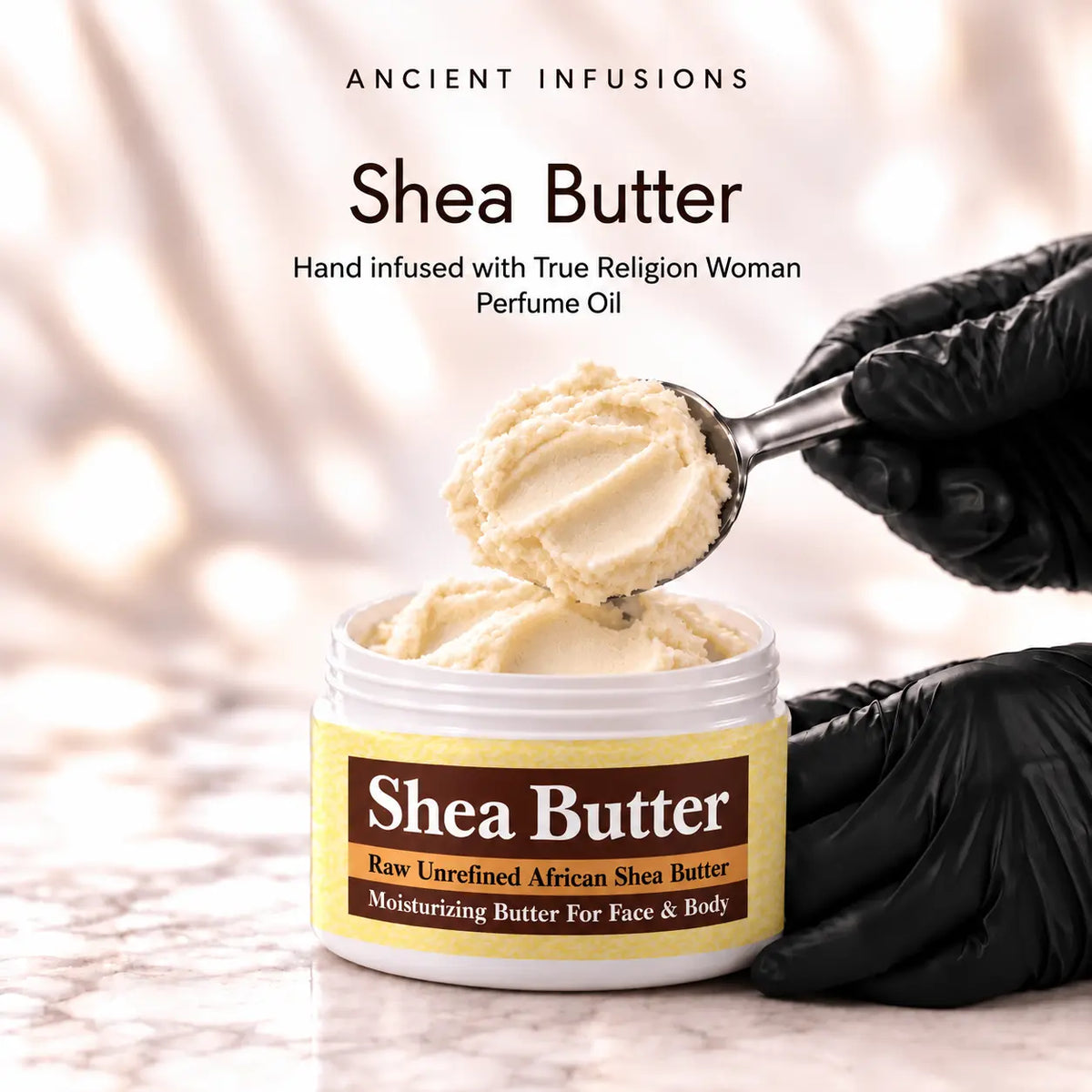 Black vinyl-gloved hands scoop raw shea butter hand infused with True Religion Woman perfume oil.