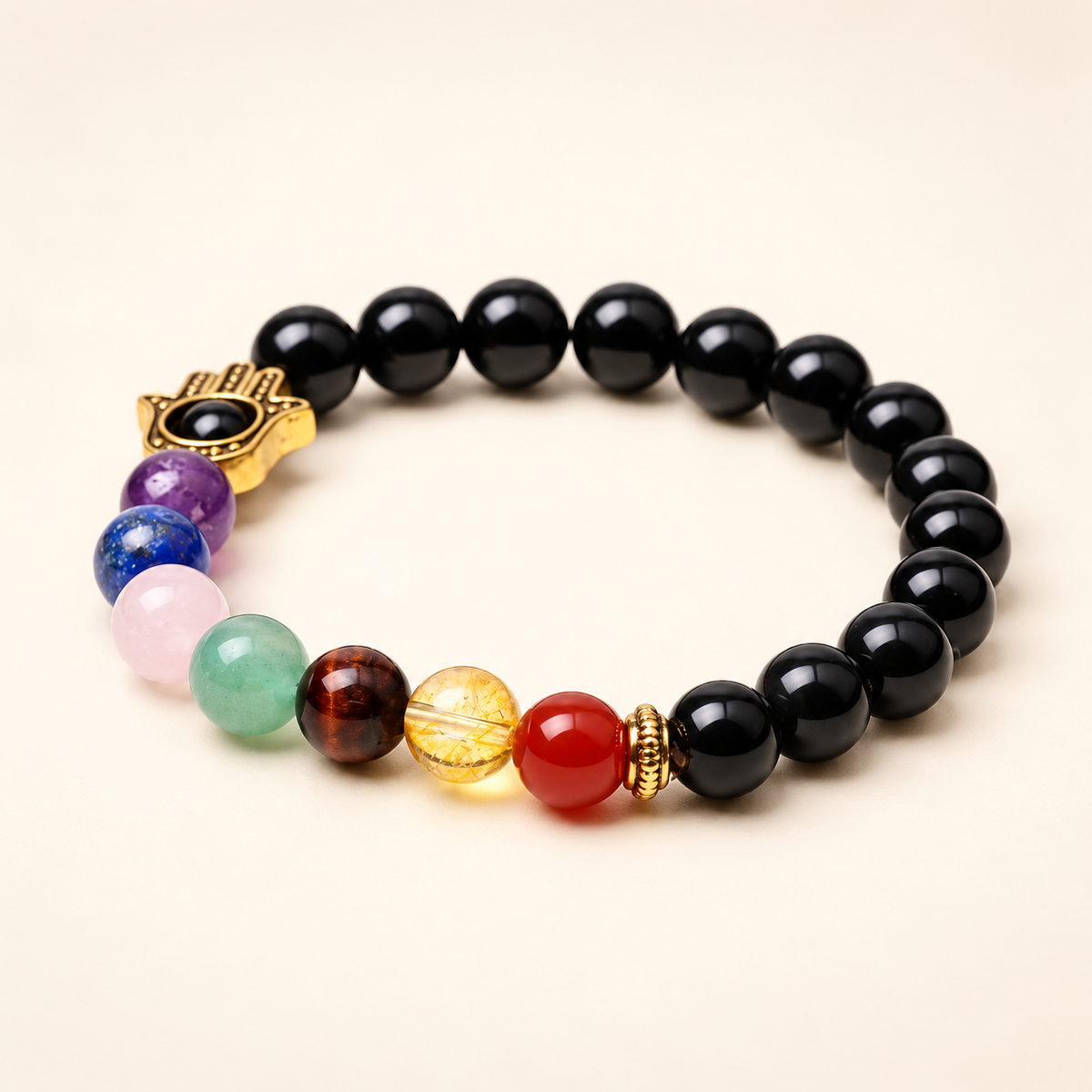 7 Chakra Black Obsidian Hamsa Elastic Bracelet on a soft ivory background