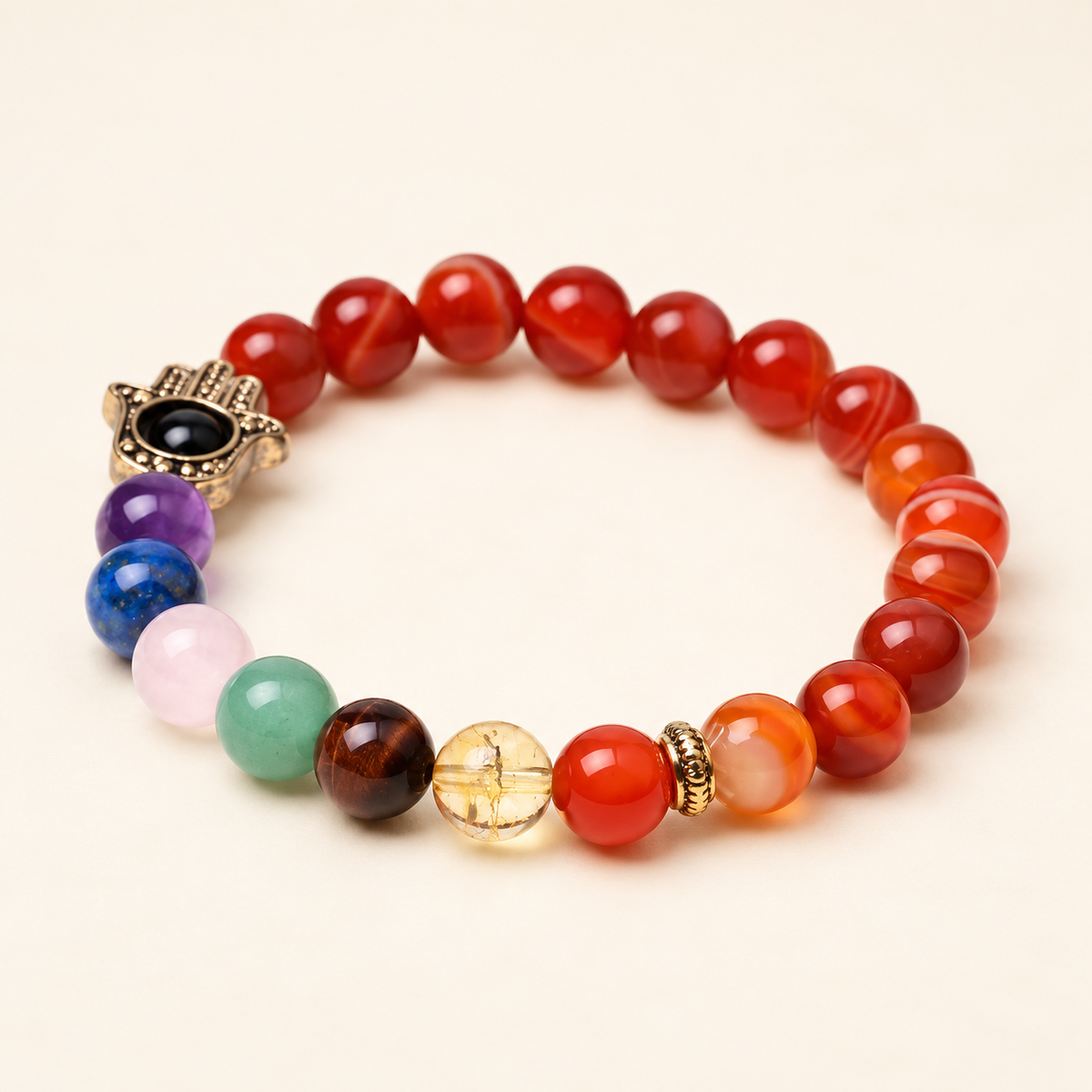 7 Chakra Carnelian Hamsa Elastic Bracelet on a soft ivory background