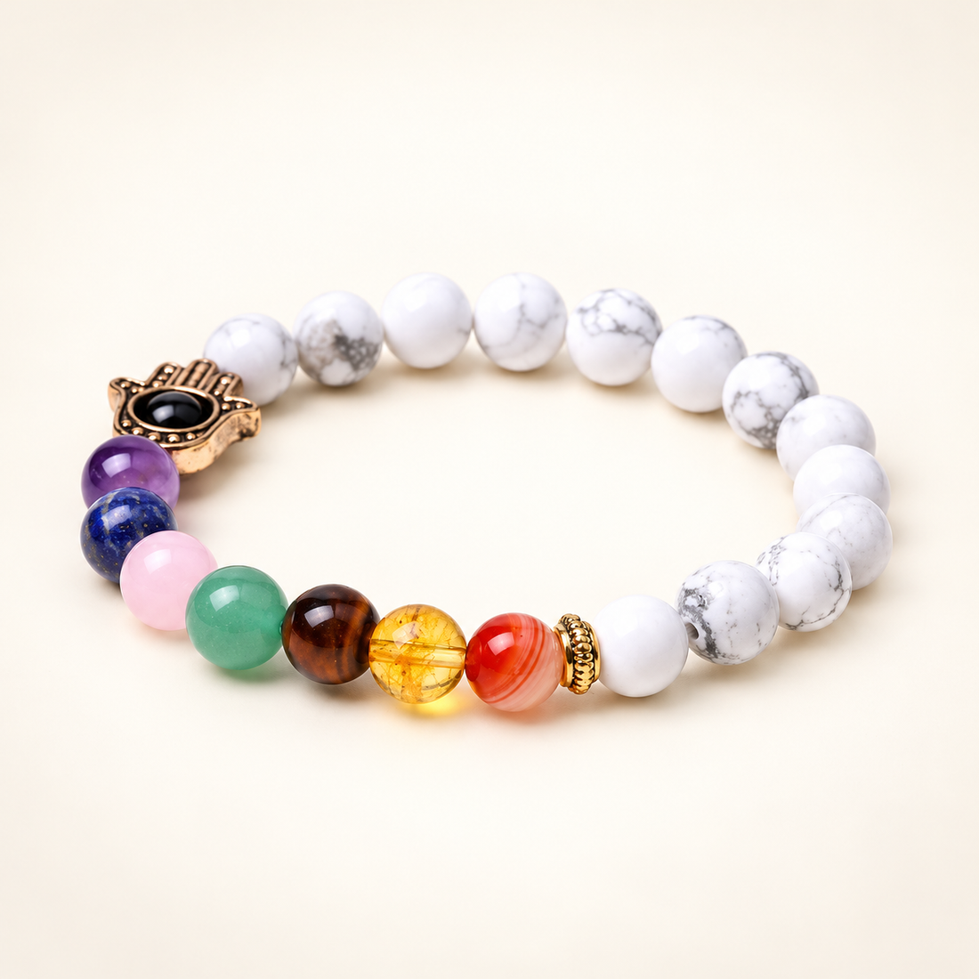 7 Chakra Howlite Bracelet with Hamsa Charm for Balance on a soft ivory background, view 1