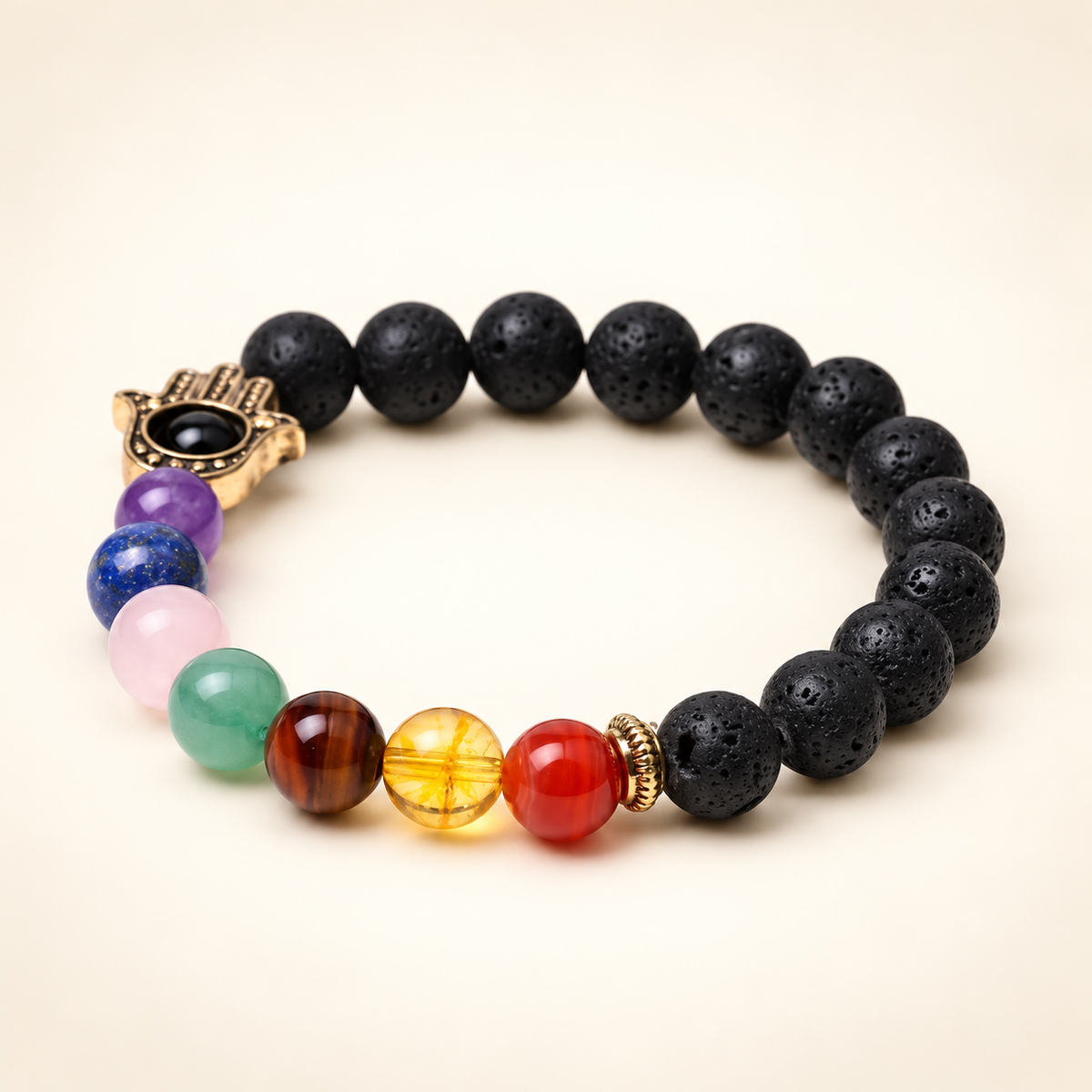 7 Chakra Lava Stone Hamsa Elastic Bracelet on a soft ivory background, view 2