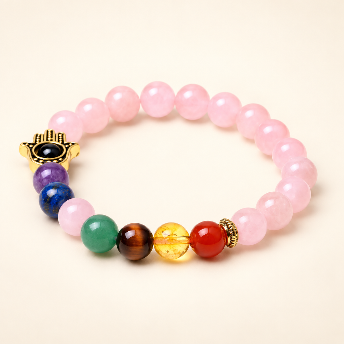 7 Chakra Rose Quartz Hamsa Elastic Bracelet on a soft ivory background, view 2