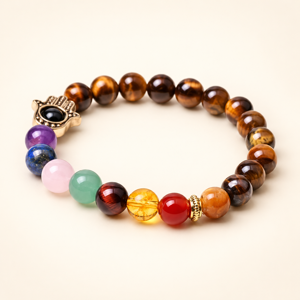 7 Chakra Tiger’s Eye Hamsa Elastic Bracelet on a soft ivory background, view 2