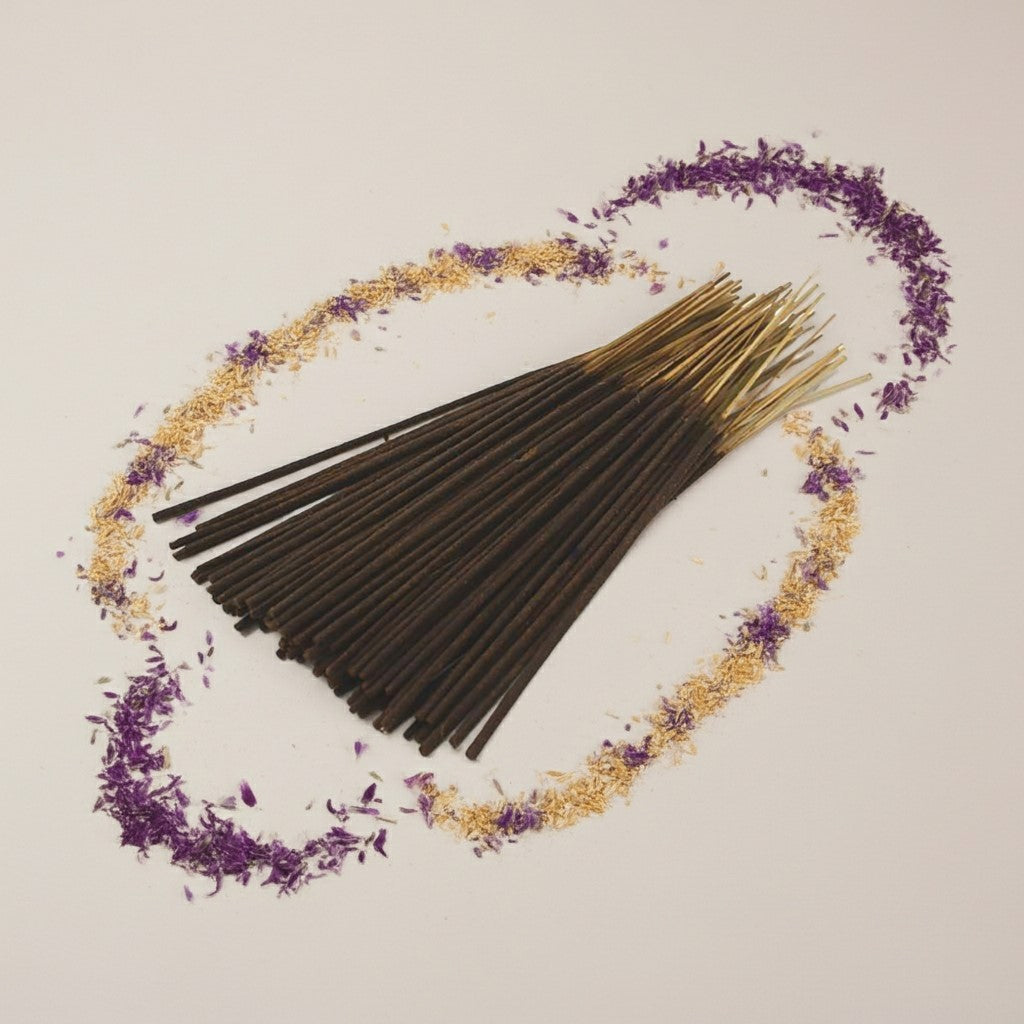 Imported Alien Inspired Incense Sticks with gold cones and lavender flowers on a light gray background