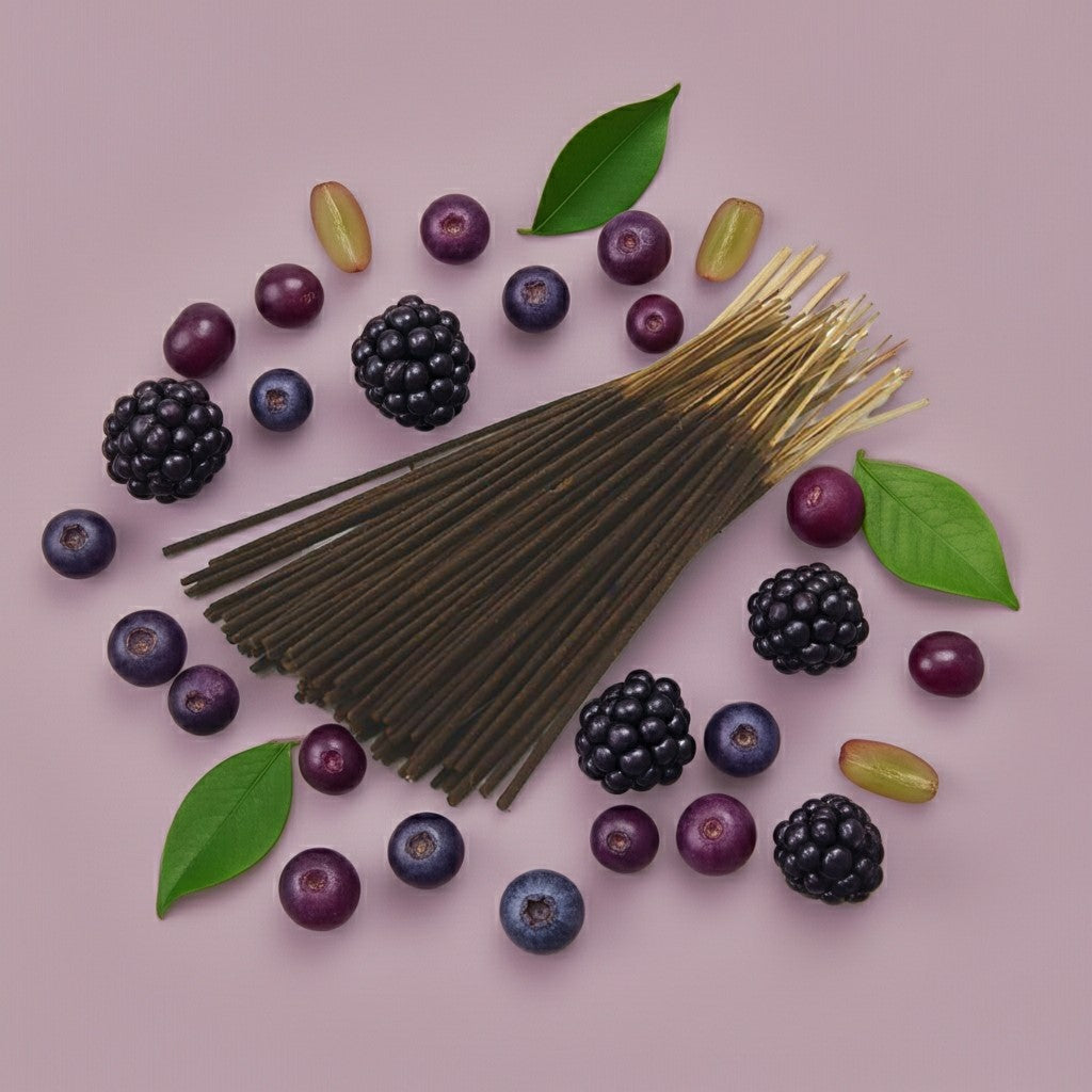 Imported Blueberry Grapes Incense Sticks with a pink ribbon surrounded by blueberries and leaves on a pink background