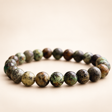 African Turquoise Elastic Bracelet on a soft ivory background, view 1