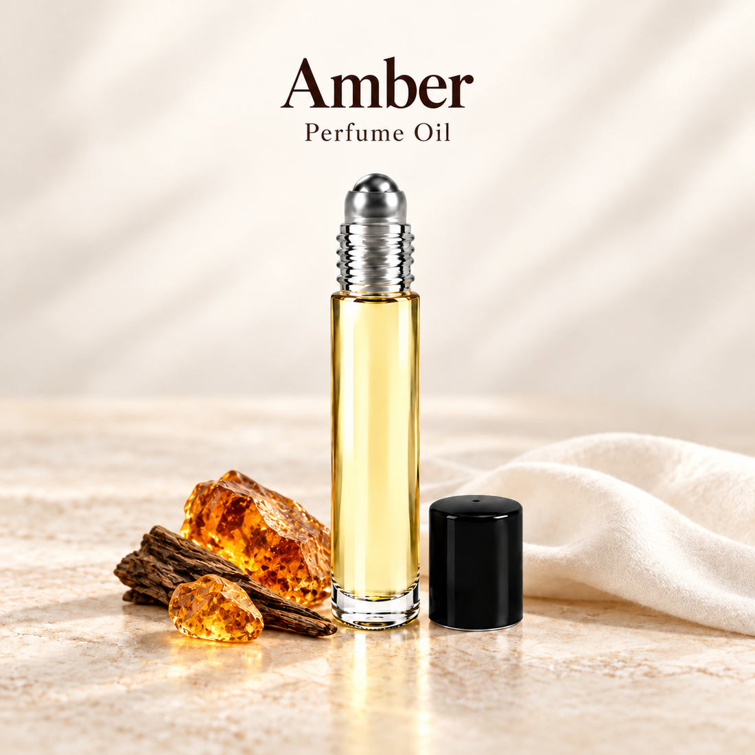 Amber Perfume Oil with simple scent note accents on soft ivory