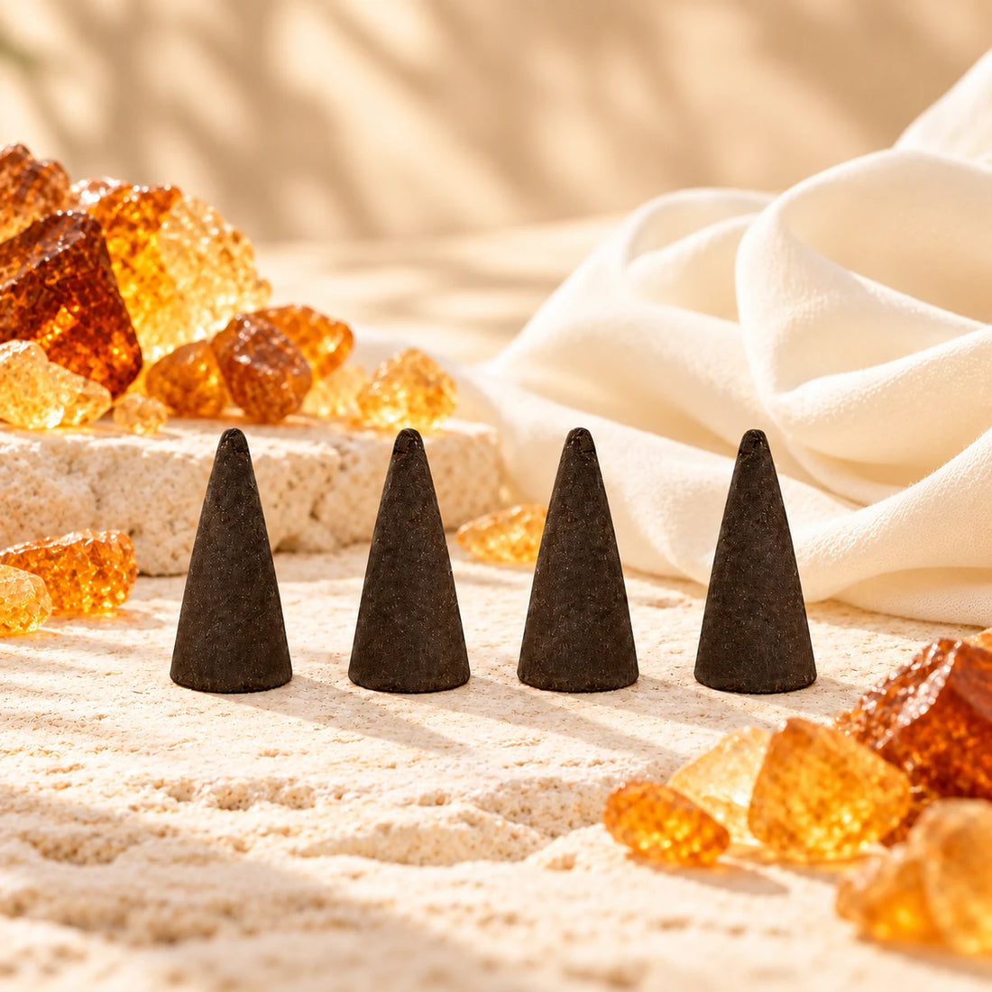 Amber White incense cones with golden amber resin and ivory fabric.