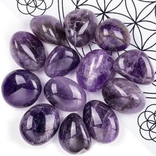 Genuine Amethyst tumbled stones showcasing their rich purple hues and spiritual healing properties.