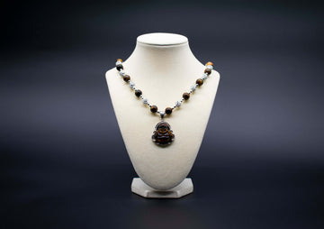 Tiger's Eye Laughing Buddha Beaded Necklace pendant, handcrafted with genuine crystals to promote joy, abundance, and positive energy.