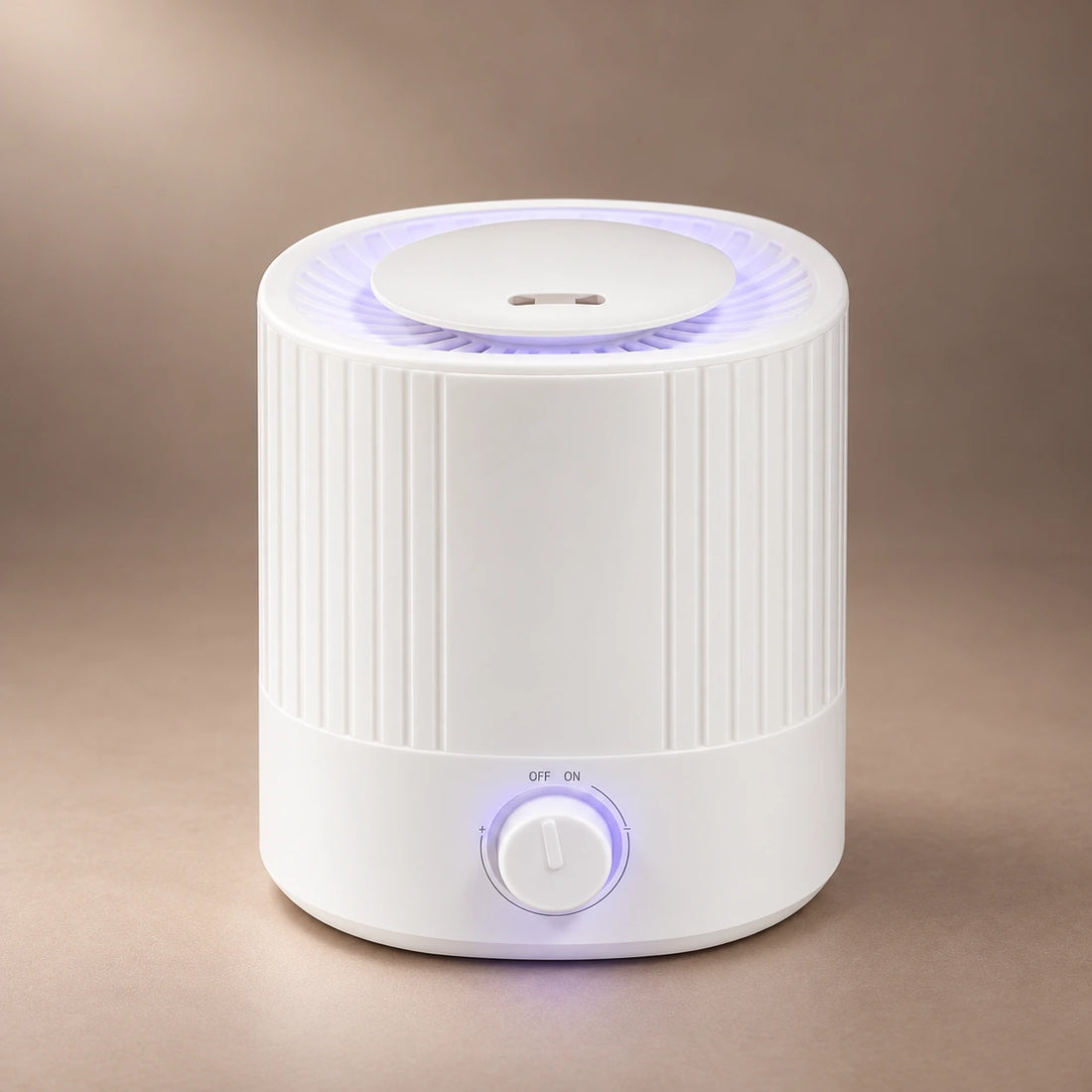 White 2.5L ultrasonic aroma diffuser with a ribbed tank, adjustable mist dial and cool mist rising from the top.
