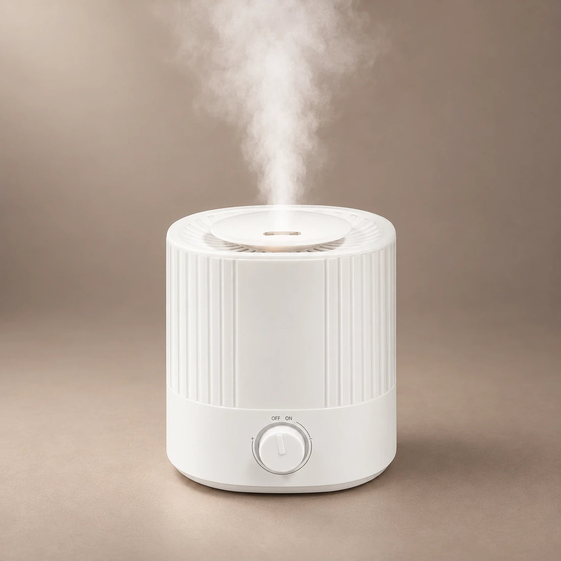 White 2.5L ultrasonic aroma diffuser with a ribbed tank, adjustable mist dial and cool mist rising from the top.