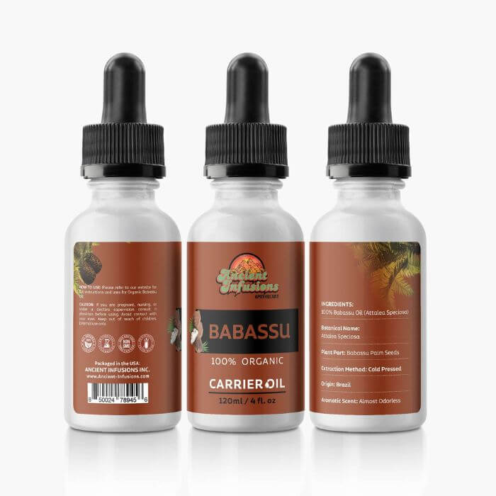 Bottle of 100% Pure Babassu Carrier Oil with coconuts and spa accessories.