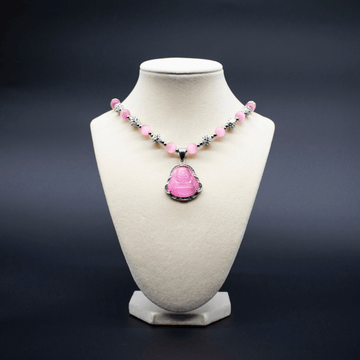 Ancient Infusions Custom Beaded Pink Cat’s Eye Necklace with Laughing Buddha pendant, handcrafted with genuine crystals to promote joy, abundance, and positive energy.