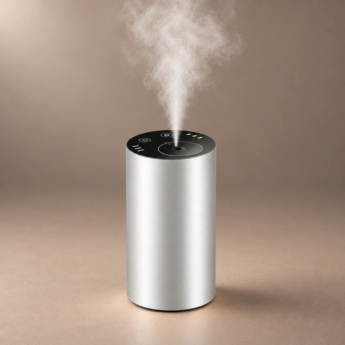 Silver DRIVE waterless car diffuser releasing fragrance from its top nozzle.