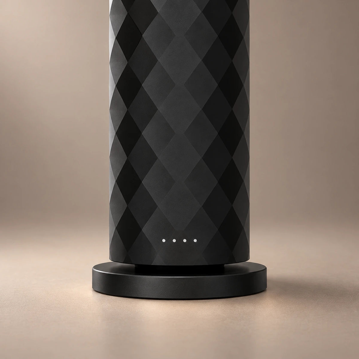 Close-up of the black HAVEN Air diffuser's diamond faceting, indicator lights and circular base.