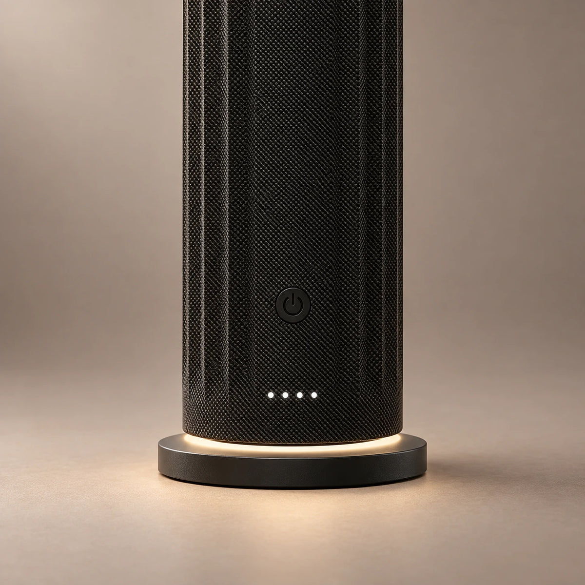 Close-up of the black HAVEN Air Pro diffuser's power control, indicator lights and illuminated base.