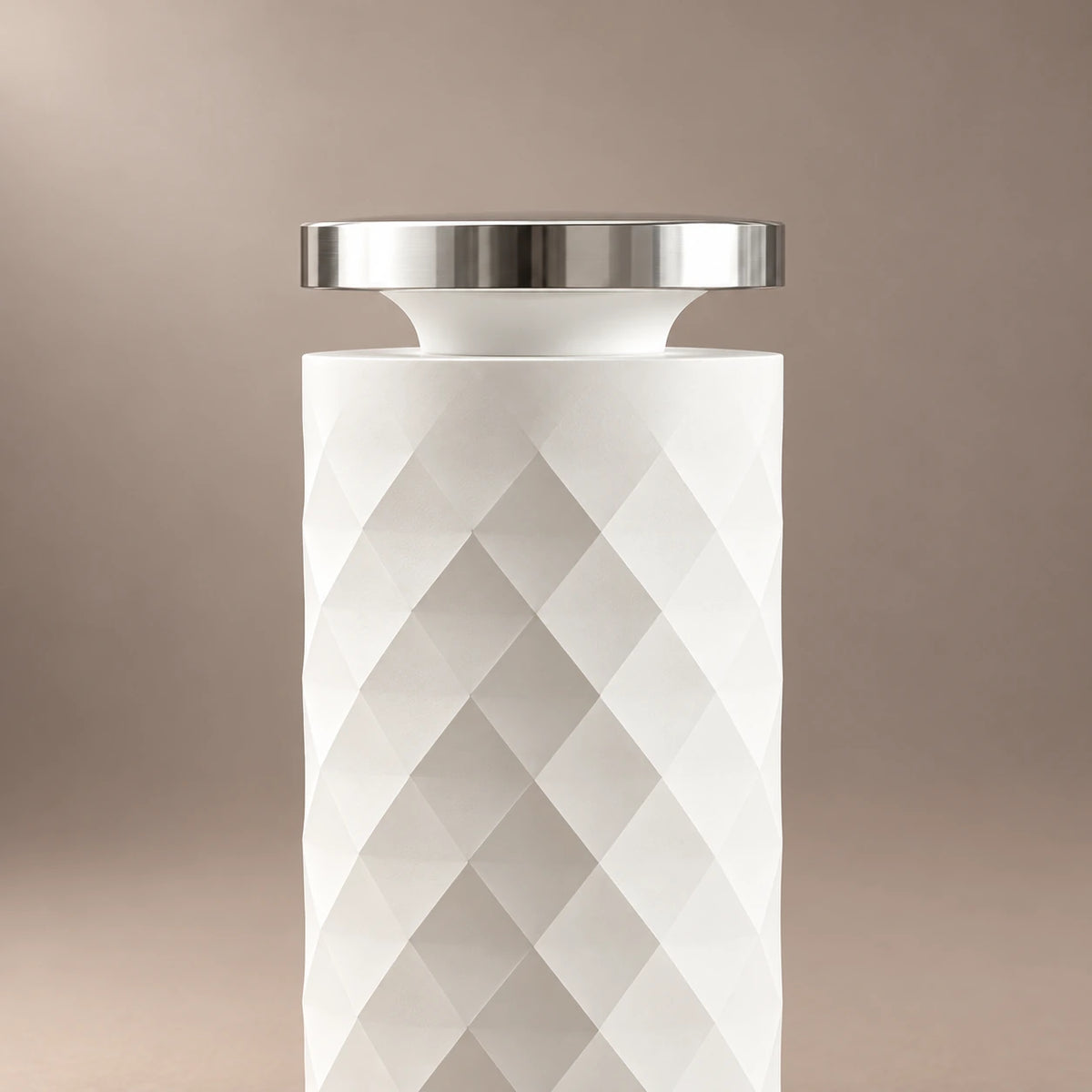 Close-up of the white HAVEN Air diffuser's silver top cap and diamond textured body.