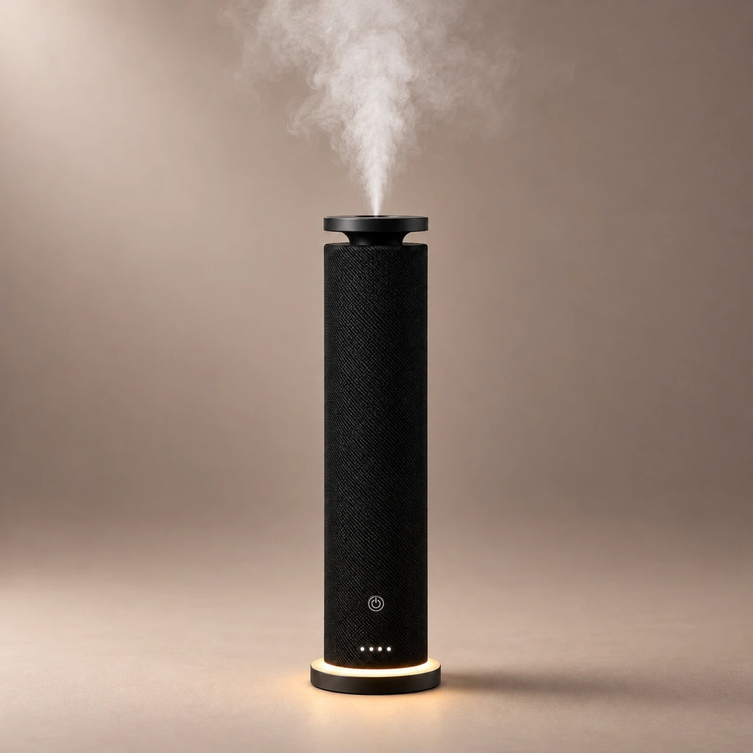 Black HAVEN waterless diffuser with a woven fabric body, warm base light and fragrance cloud.