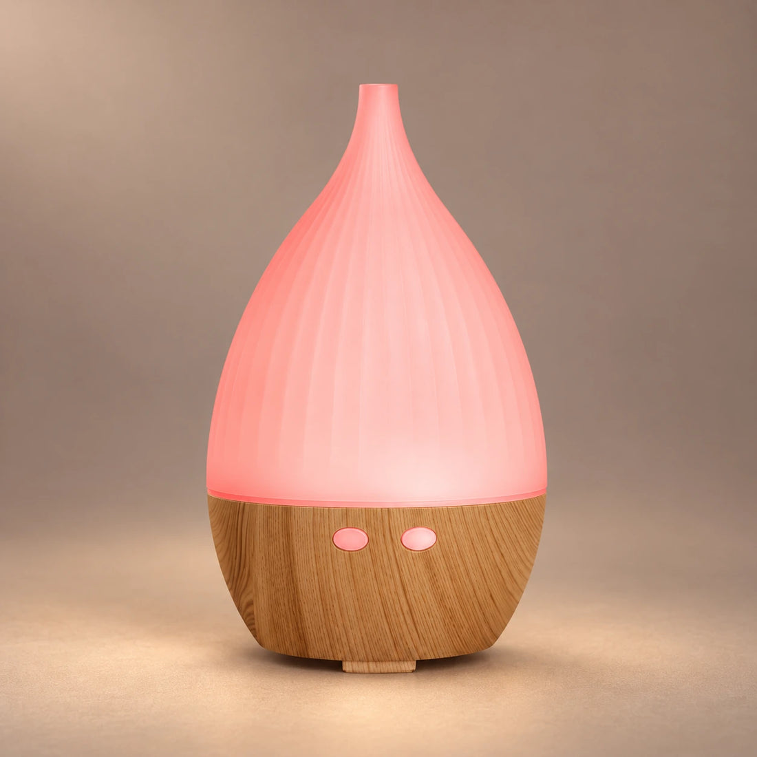 Teardrop ultrasonic aroma diffuser with a pink LED cover, wood grain base and visible cool mist.