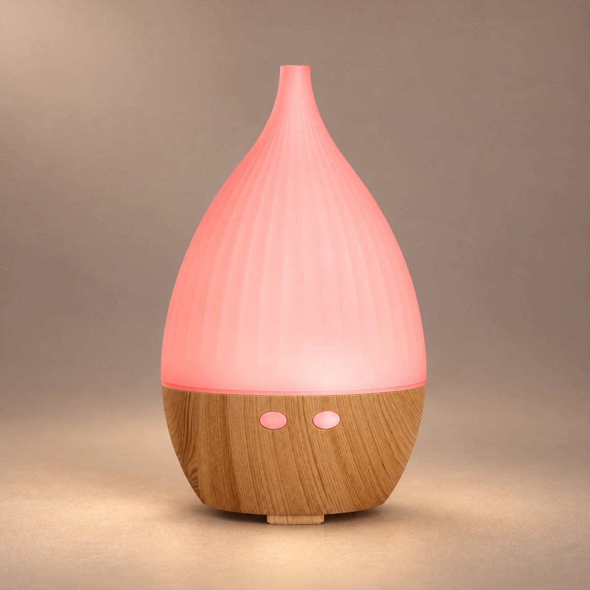 Teardrop LED aroma diffuser showing its ribbed pink cover and wood grain base.