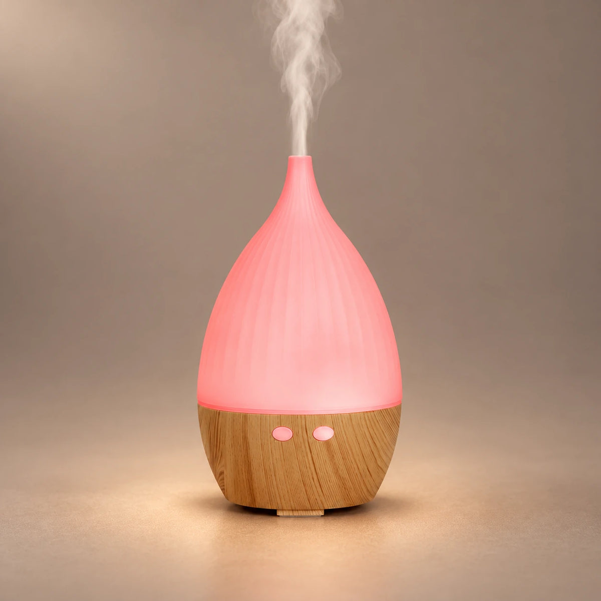 Teardrop ultrasonic aroma diffuser with a pink LED cover, wood grain base and visible cool mist.