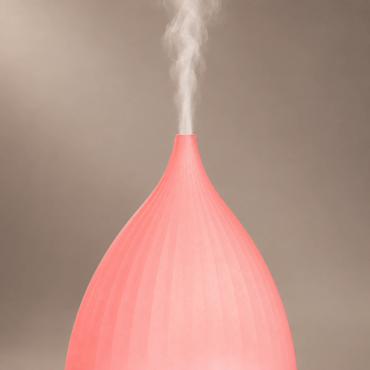 Teardrop diffuser showing the narrow mist outlet and ribbed pink LED cover.