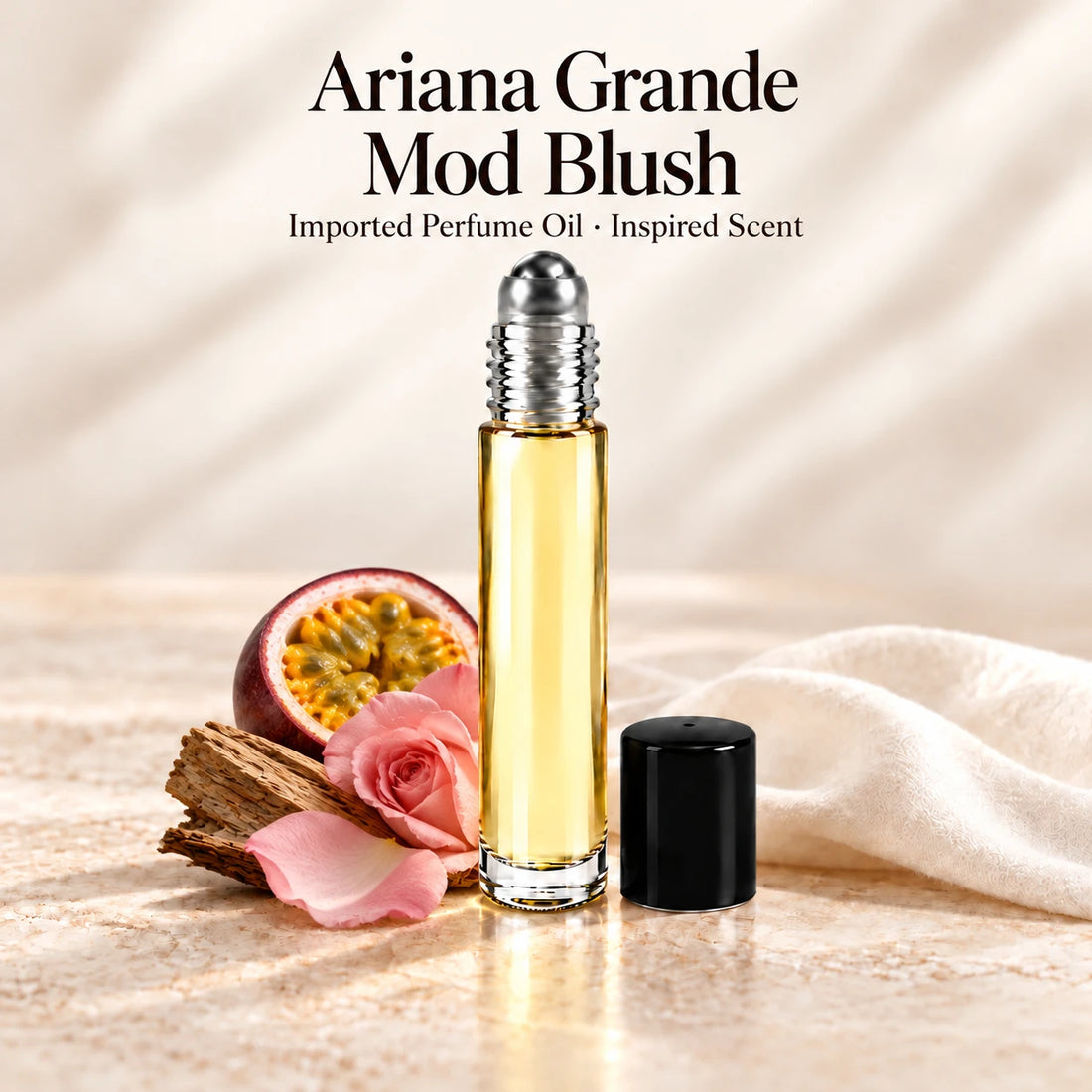 Ariana Grande Mod Blush Perfume Oil in a slim glass roll-on bottle with a silver roller and black cap on an ivory stone surface.