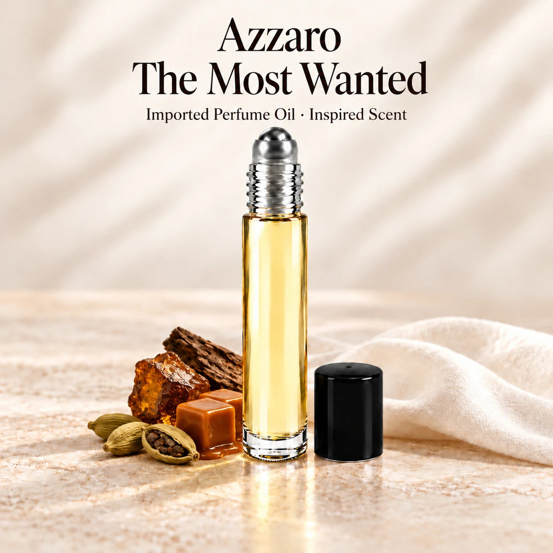 Azzaro The Most Wanted Perfume Oil in a slim glass roll-on bottle with a silver roller and black cap on an ivory stone surface.
